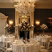 Wedding flowers: Claridge's hotel. Tall vase arrangement